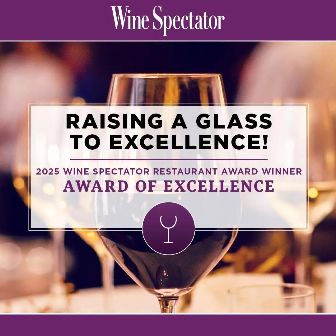 A wine glass with award text overlay, Wine Spectator header in purple.